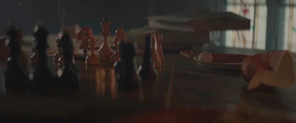 A close view of game pieces, props and draped fabric on the table in the Betboom film.
