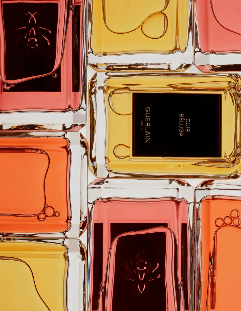Close-up of stacked Guerlain perfume bottles