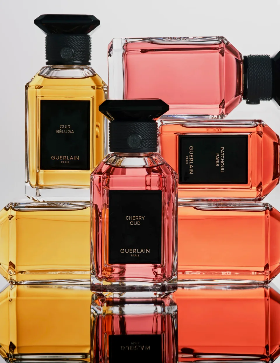 Guerlain perfume bottles arranged on a white background