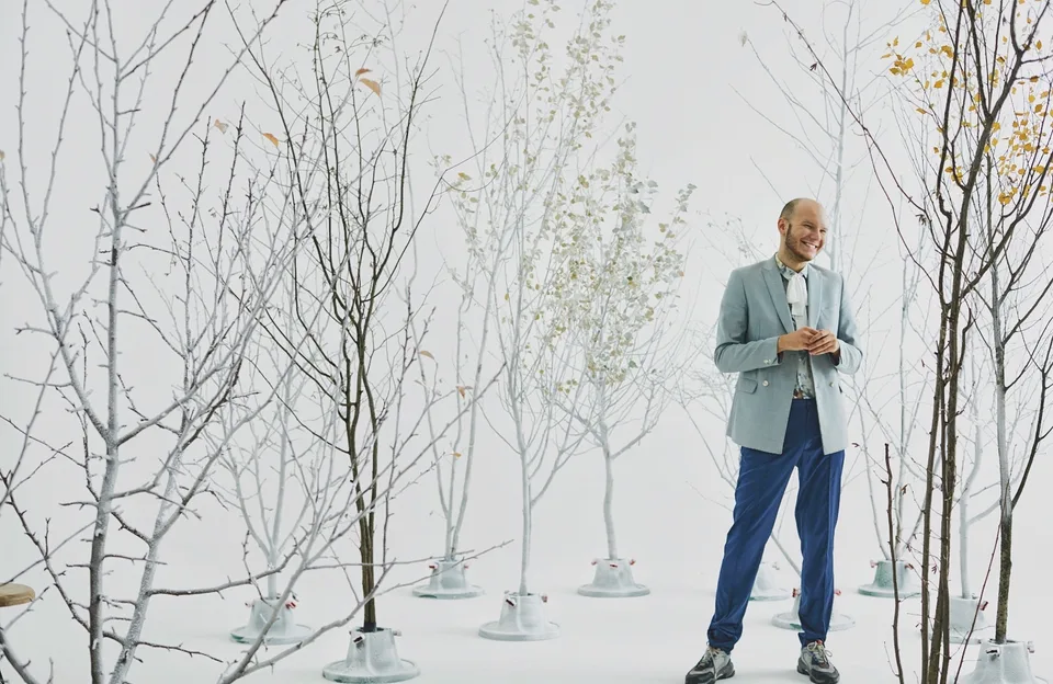 Behind-the-scenes view of the trees arranged across the white Louis Vuitton studio set.