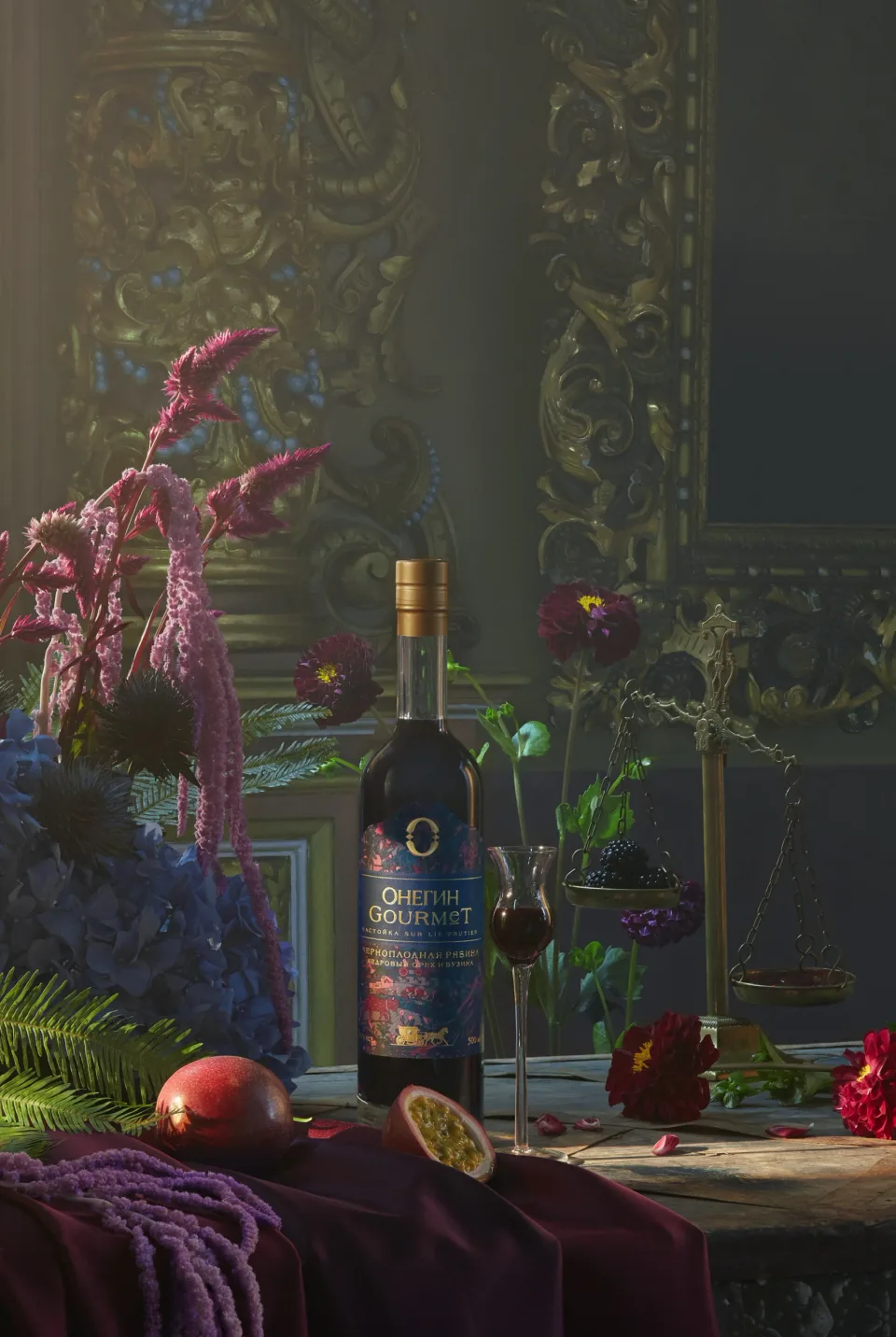 Onegin Gourmet bottle on an ornate table surrounded by flowers, greenery, fruit, a glass and a small hanging balance scale.
