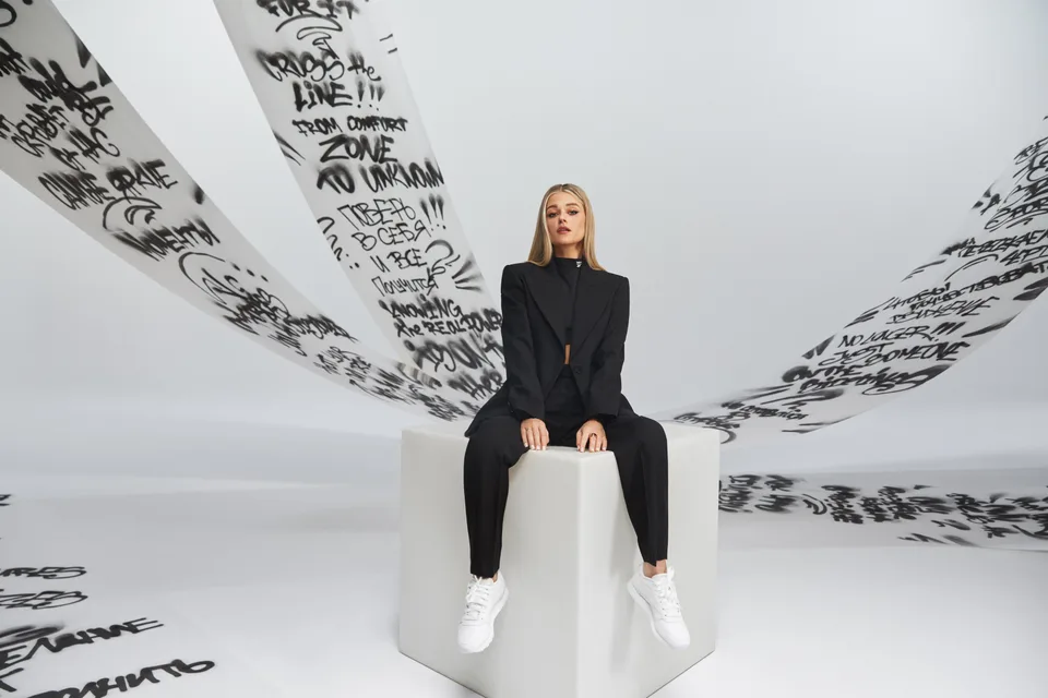 Closer view of a model framed by the handwritten graphic backdrop.