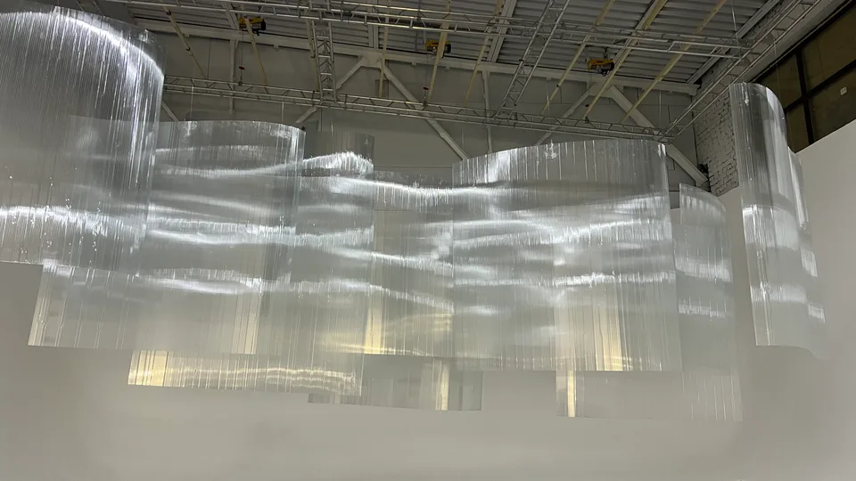 The installed curved translucent walls before the campaign lighting and models.